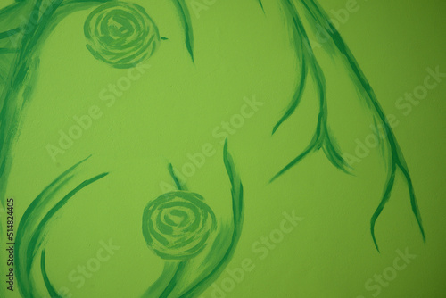 floral pattern painted on the wall, green abstract crooked shape on green light background, green wallpaper