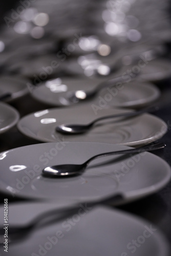 Long row of spoon dishes placed along a bar or table