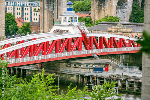 A grade II listed swing bridge over the River Tyne, England, connecting Newcastle upon Tyne and Gateshead, and lying between the Tyne Bridge and the High Level Bridge. photo