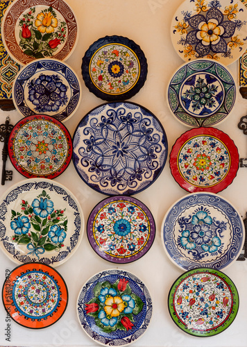 COLOURED CERAMIC PLATES ON A WHITE WALL