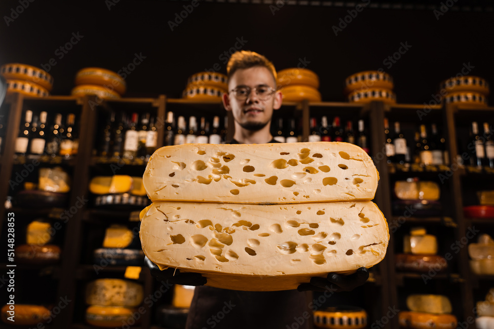 Handsome cheese sommelier with 2 half of yellow cheese wheel limited