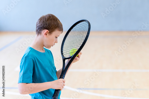 Sad disappointed boy with tennis racket and ball in a physical education lesson © Augustas Cetkauskas