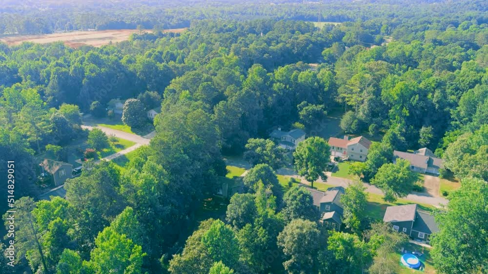 majestic aerial footage of lush green trees with homes nestled among