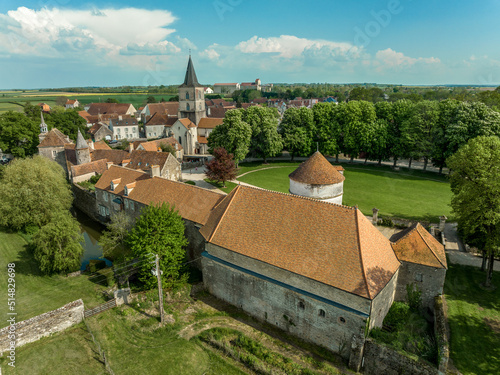 Aerial view of the feudal castle of Epoisses with buildings from the 10th century and major updates from the 14th and 18th century. The castle has a large defensive moat all around