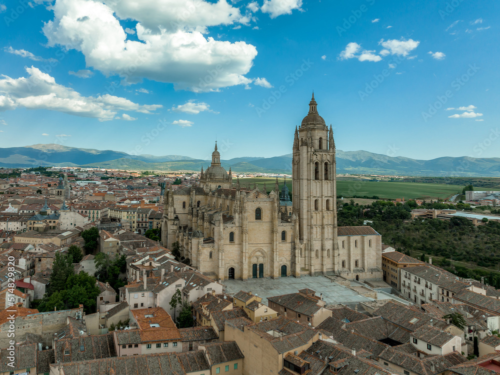 Aerial view of the ornate late Gothic Cathedral of Segovia in Spain with cloudy blue sky
