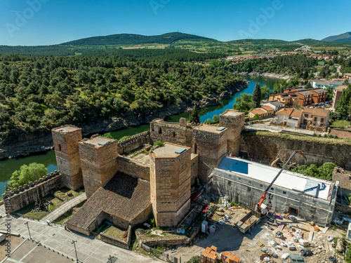 Aerial view of the medieval castle in Buitrago de Lozoya, Spain, with large square towers along the river photo