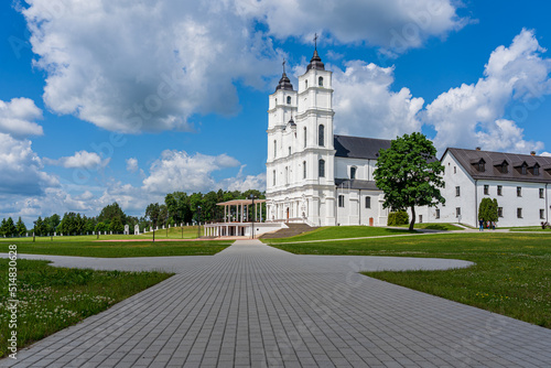 Fotografie White Catholic Church on the background of blue sky