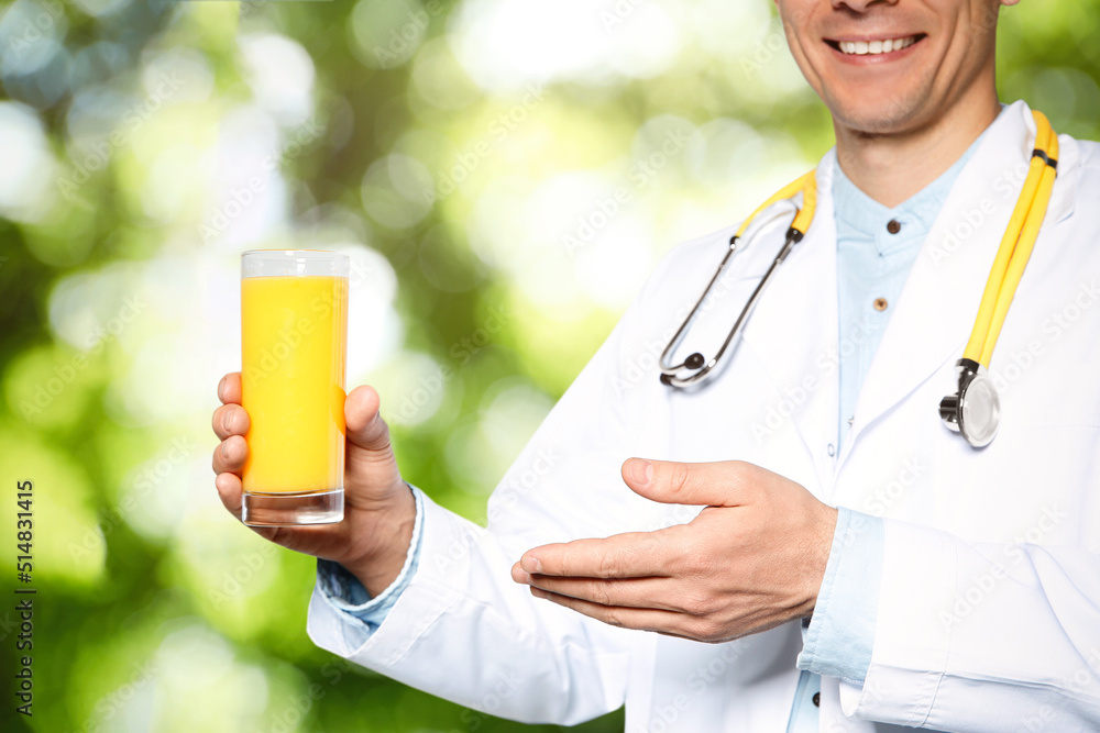 Nutritionist with glass of juice on blurred green background, closeup Nutritionist with glass of juice on blurred green background, closeup