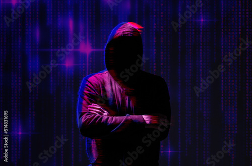 Silhouette of anonymous hacker and digital binary code on dark background. Cyber attack concept