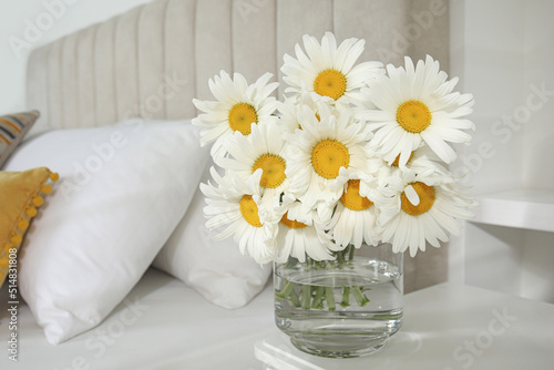 Fototapeta Naklejka Na Ścianę i Meble -  Bouquet of beautiful daisy flowers on table in bedroom, space for text