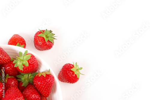 Red ripe strawberry in the white bowl