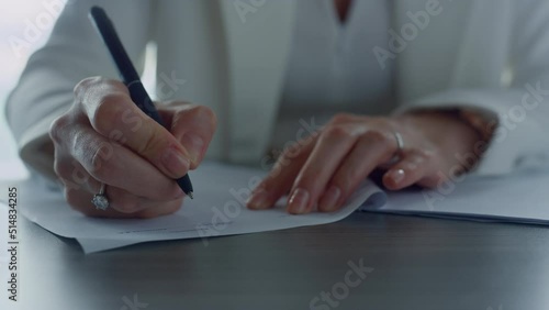 Businesswoman hand signing report in office closeup. Financial manager approving photo
