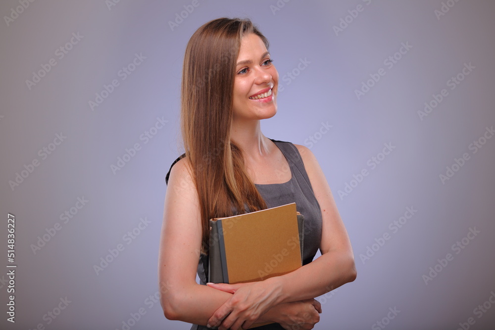 teacher woman or adult student standing with book or workbook looking away, Isolated female portrait. teacher woman or adult student standing with book or workbook looking away, Isolated female portrait.