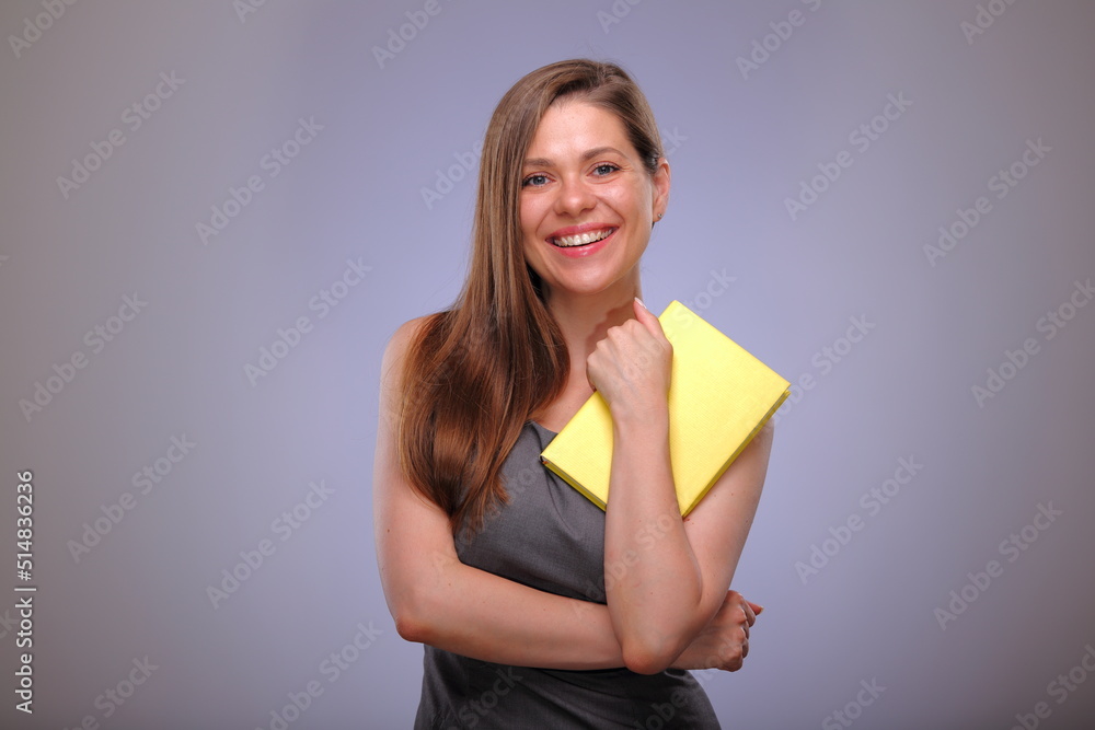 Woman teacher or adult student, smiling business person, Isolated female portrait with yellow book. Woman teacher or adult student, smiling business person, Isolated female portrait with yellow book.