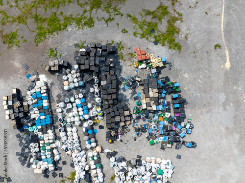 Illegal storage of solid household waste, plastic bottles and garbage bags. Land pollution. Aerial top view. photo
