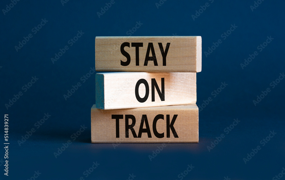 Stay on track symbol. Concept words Stay on track on wooden blocks on a beautiful grey table grey background. Business, motivational and stay on track concept. Copy space. Stay on track symbol. Concept words Stay on track on wooden blocks on a beautiful grey table grey background. Business, motivational and stay on track concept. Copy space.