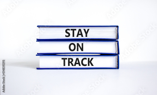 Stay on track symbol. Concept words Stay on track on books on a beautiful white table white background. Business, motivational and stay on track concept. Copy space.