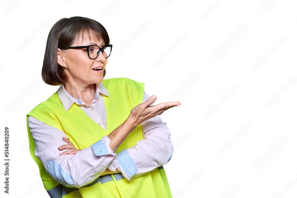Industrial woman in safety vest on white isolated background pointing to the side, copyspace