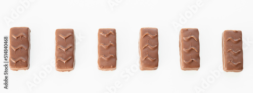 Pile of chocolate sweets with nougat  caramel and nuts isolated on white background.
