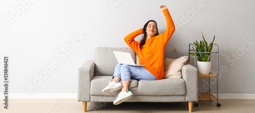 Happy young woman with lapt...