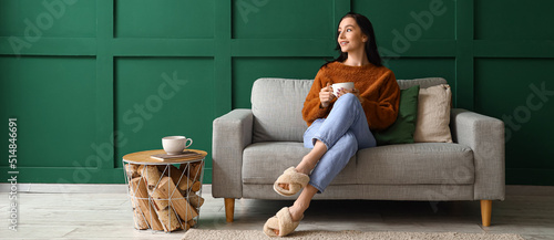 Happy young woman with cup ...