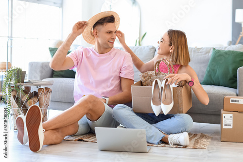 Young couple unpacking box ...