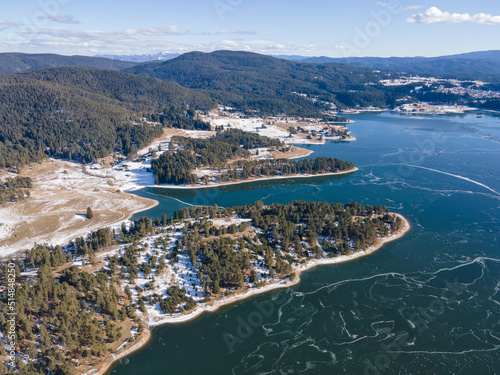 Aerial winter view of Dospat Reservoir covered with ice, Bulgaria