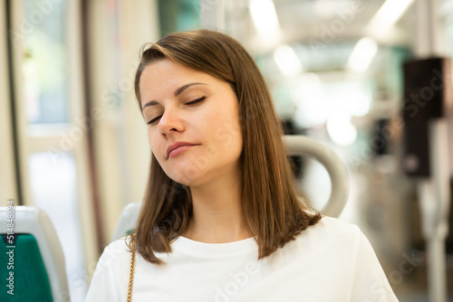 Tired young woman sleeping on seat in public transport Free Download Tired young woman sleeping on seat in public transport - GFXLoad