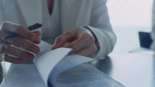 Businesswoman hands checking contract closeup. Lawyer reading legal documents photo