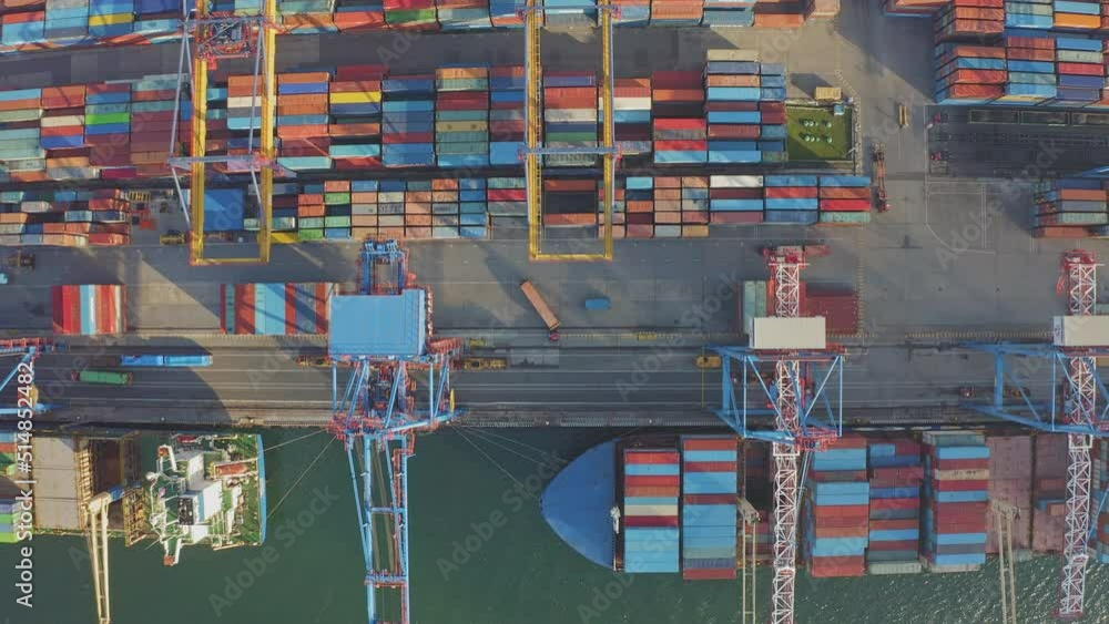 Loading and unloading a container ship in the port at the pier. Aerial ...