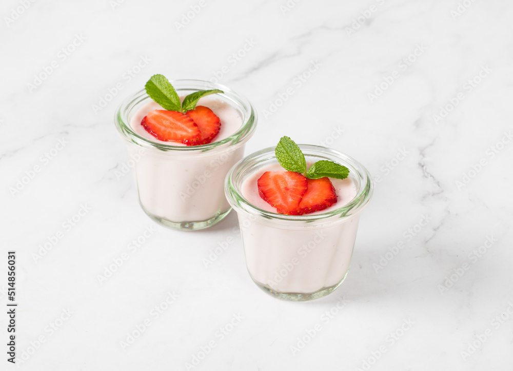 Strawberry cream pudding, Panna Cotta in a glass. Light background Strawberry cream pudding, Panna Cotta in a glass. Light background
