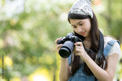 Asian woman holding camera © nokkaew