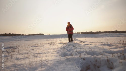 traveler snowy mountains with backpack sunset walks through snow. climber travels alone winter. walk through winter forest. hiking snow. active young man walks with his feet snow sunrise. concept.