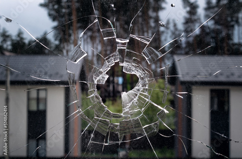 Фотография Broken window glass on a background houses