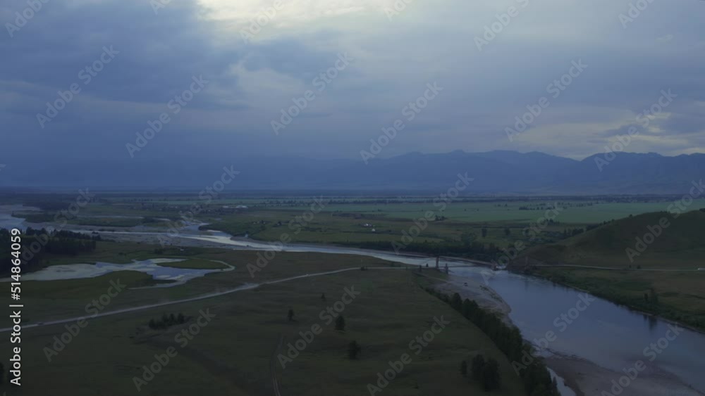 Aerial of majestic river Katun and valley of Altai under sunset sky, Siberia, Russia. Beautiful summer nature landscape at during sunset. Aerial view from a drone Aerial of majestic river Katun and valley of Altai under sunset sky, Siberia, Russia. Beautiful summer nature landscape at during sunset. Aerial view from a drone