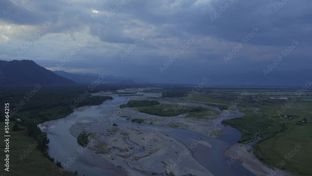 Aerial of majestic river Katun and valley of Altai under sunset sky, Siberia, Russia. Beautiful summer nature landscape at during sunset. Aerial view from a drone Aerial of majestic river Katun and valley of Altai under sunset sky, Siberia, Russia. Beautiful summer nature landscape at during sunset. Aerial view from a drone