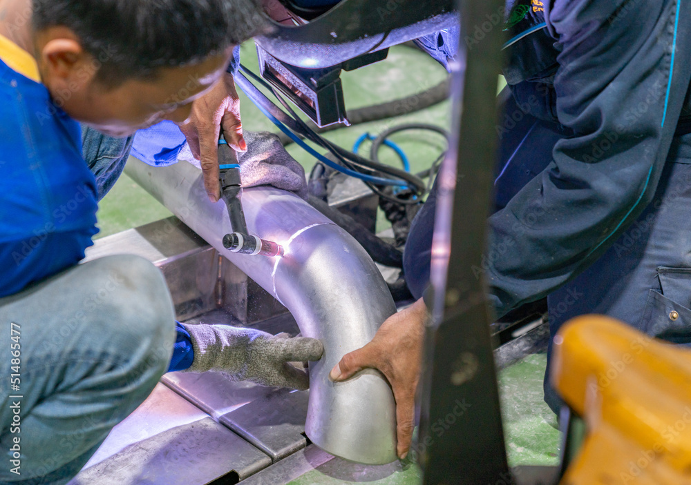 Welder argon welding stainless steel pipe at industry. Welder argon welding stainless steel pipe at industry.