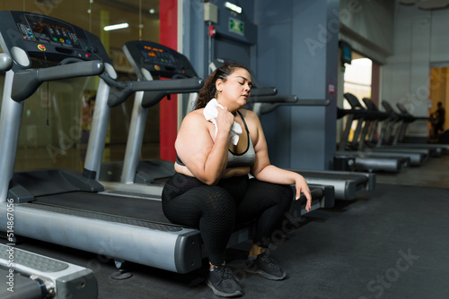 Exhausted obese woman working out
