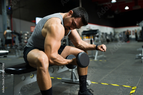 Muscular attractive man doing biceps © AntonioDiaz
