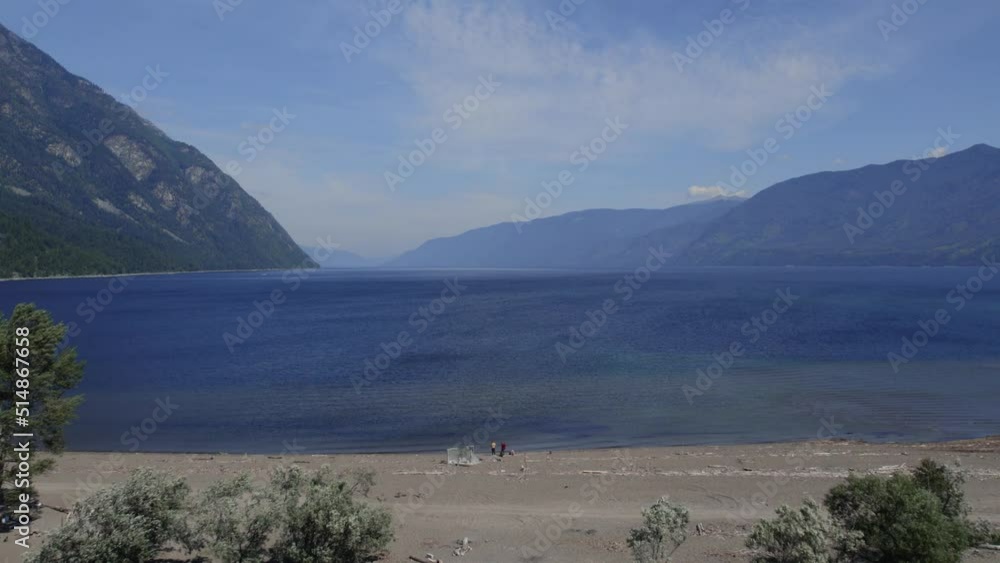 Aerial view on lake Teletskoye between mountains with blue sky in Altai, Siberia, Russia. Beautiful summer nature landscape at during daytime Aerial view on lake Teletskoye between mountains with blue sky in Altai, Siberia, Russia. Beautiful summer nature landscape at during daytime