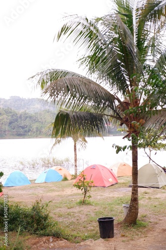beach with palm trees or camping atau berkemah di pinggir waduk sermo, yogyakarta, indonesia