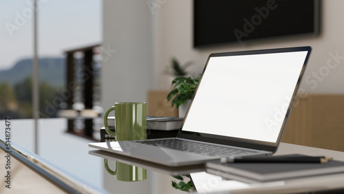 Modern portable workplace with portable notebook laptop on coffee table in home living room