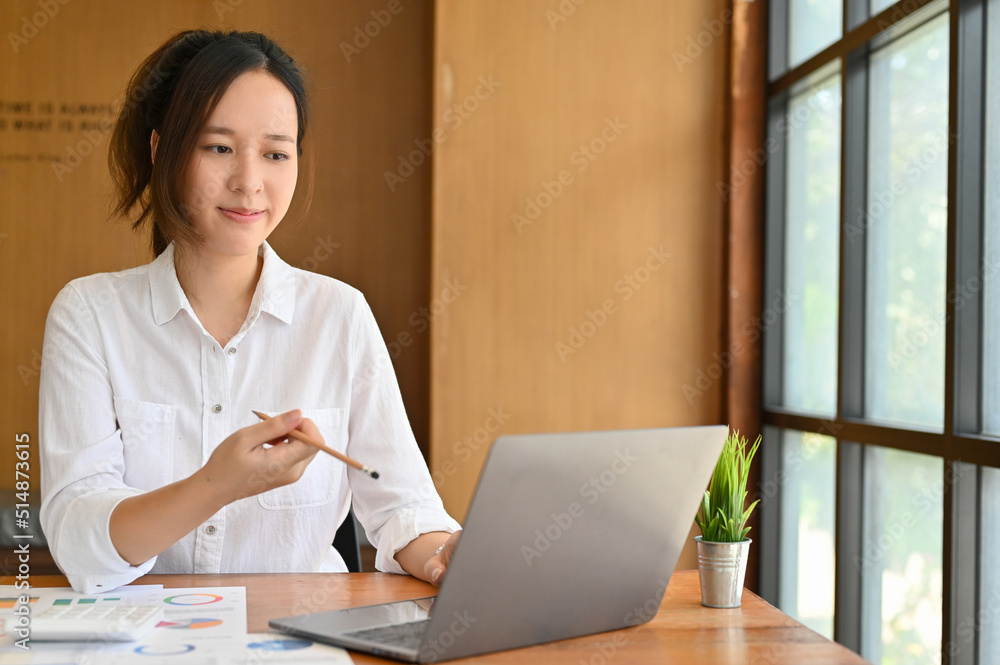 Beautiful millennial Asian businesswoman is working in the office Beautiful millennial Asian businesswoman is working in the office