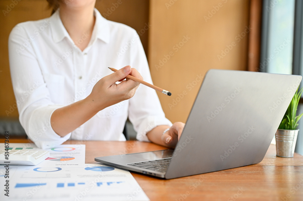 Cropped, A businesswoman working at her desk, using laptop computer Cropped, A businesswoman working at her desk, using laptop computer