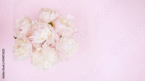 Beautiful garden peony flowers bouquet on pink background. Top view flat lay with space for your holiday greetings © Наталья некрасова