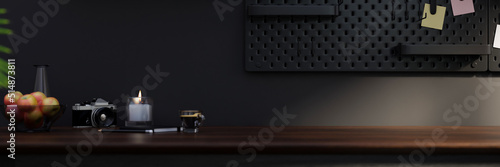 Modern dark and black home working studio design with copy space on dark wood tabletop © bongkarn