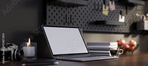 Modern dark office desk or home worktable design with laptop mockup against the black wall.