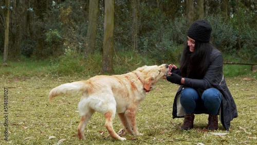 A lovely moment. Woman playing with her dog photo