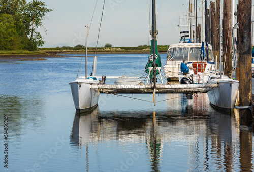 Beautiful seascape and sailing catamaran in the blue sky at the background. Sailing on Trimaran Sail Boat. photo