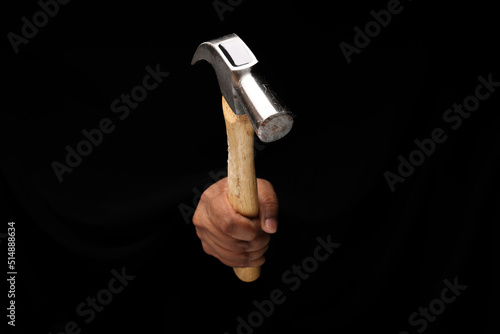 Asian male dark skinned single hand fist finger on black background holding using hammer